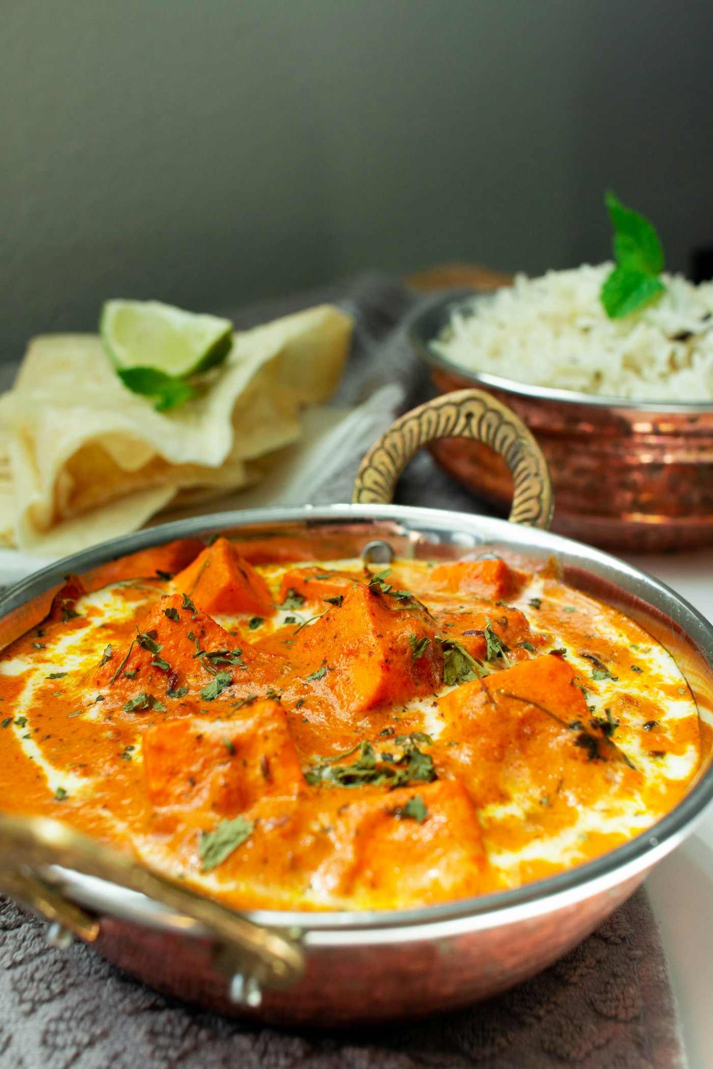 A generous bowl of paneer curry with rice and bread
